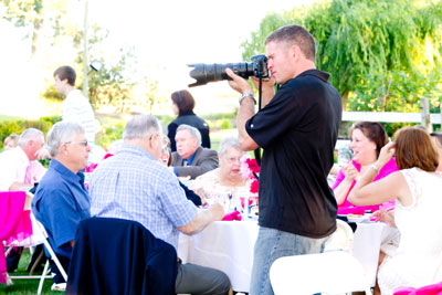 wedding photographer taking pictures at reception