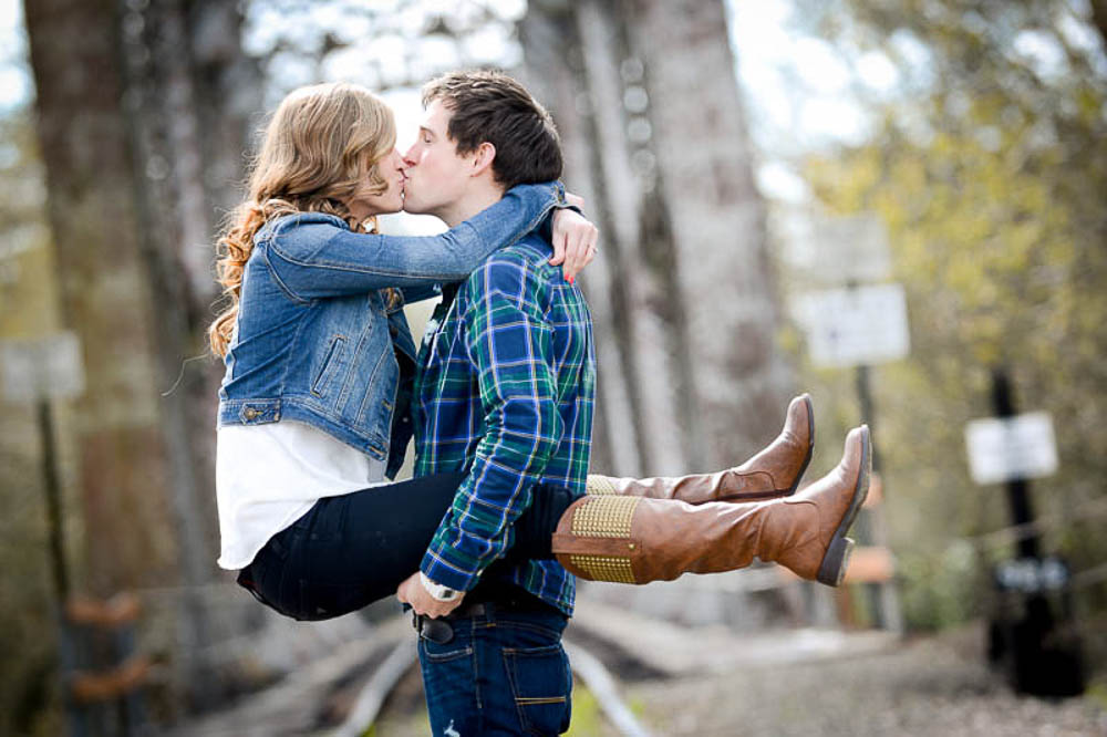 fiance holds girlfriend on railroad tracks