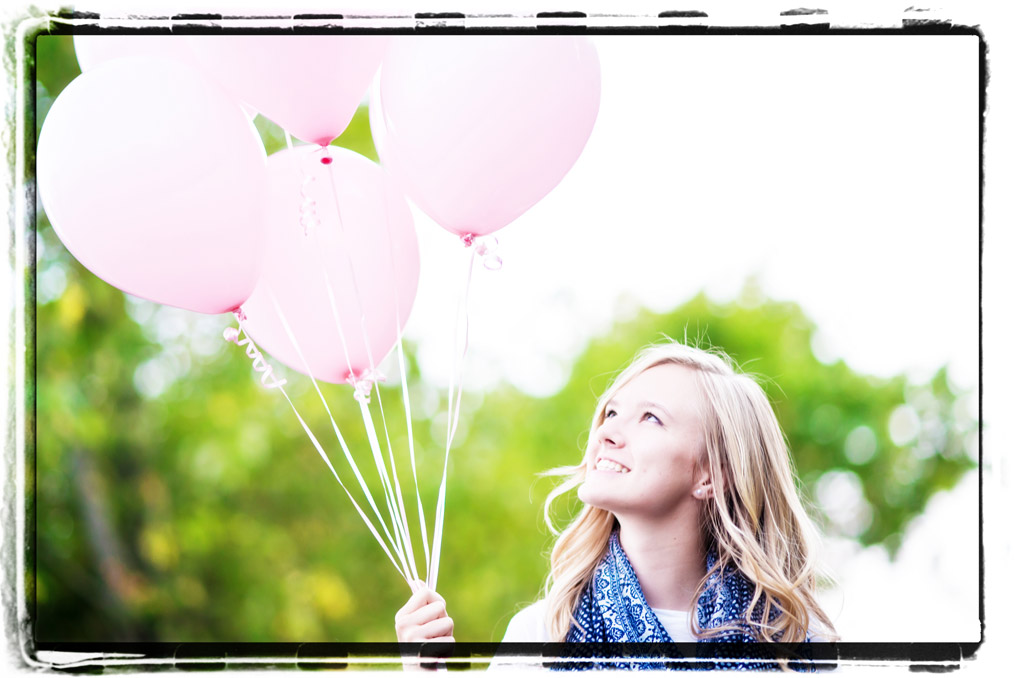 high school senior holding balloons