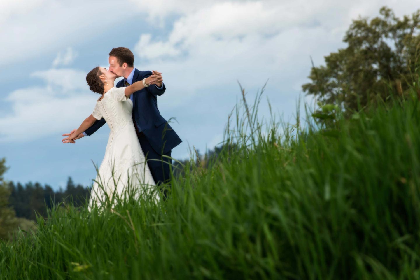 couple kissing in a field